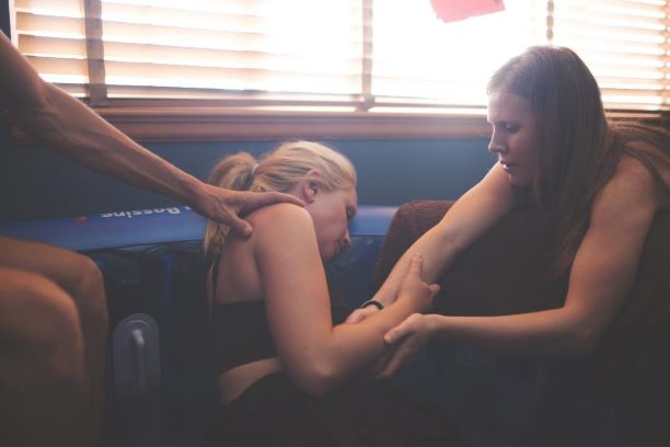 Partner/Doula helping mom in tub